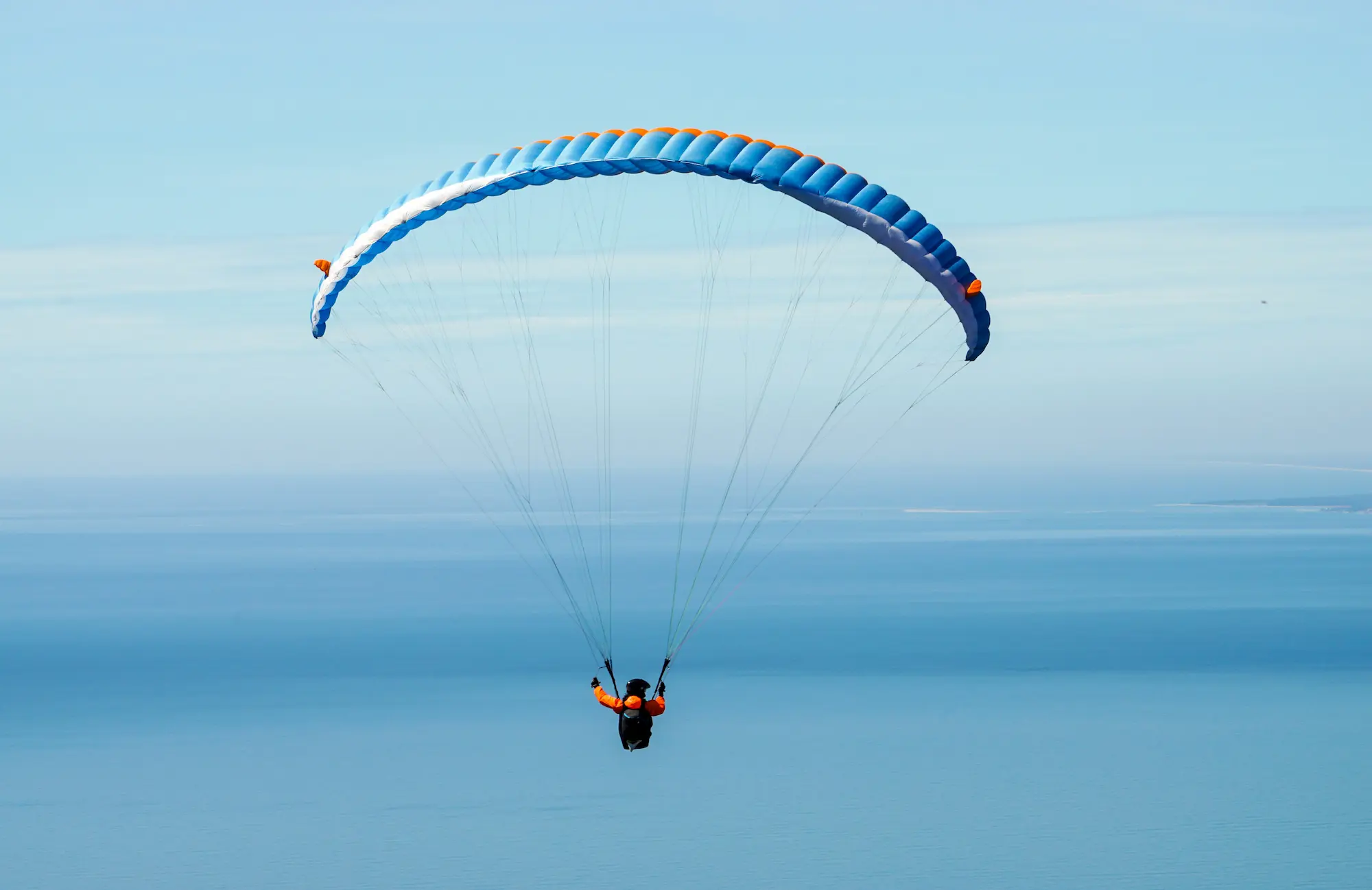 Paragliding over a mountain valley