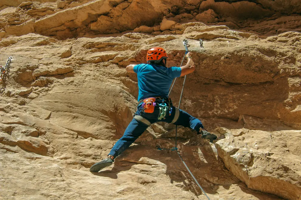 Rock climber climbing a mountain wall